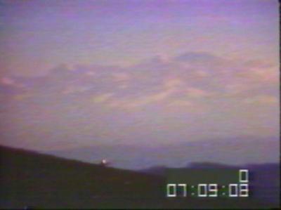Billy Meier photo - UFO dips behind hill in distance